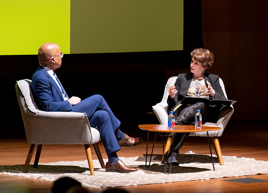 Two people in conversation on a stage.