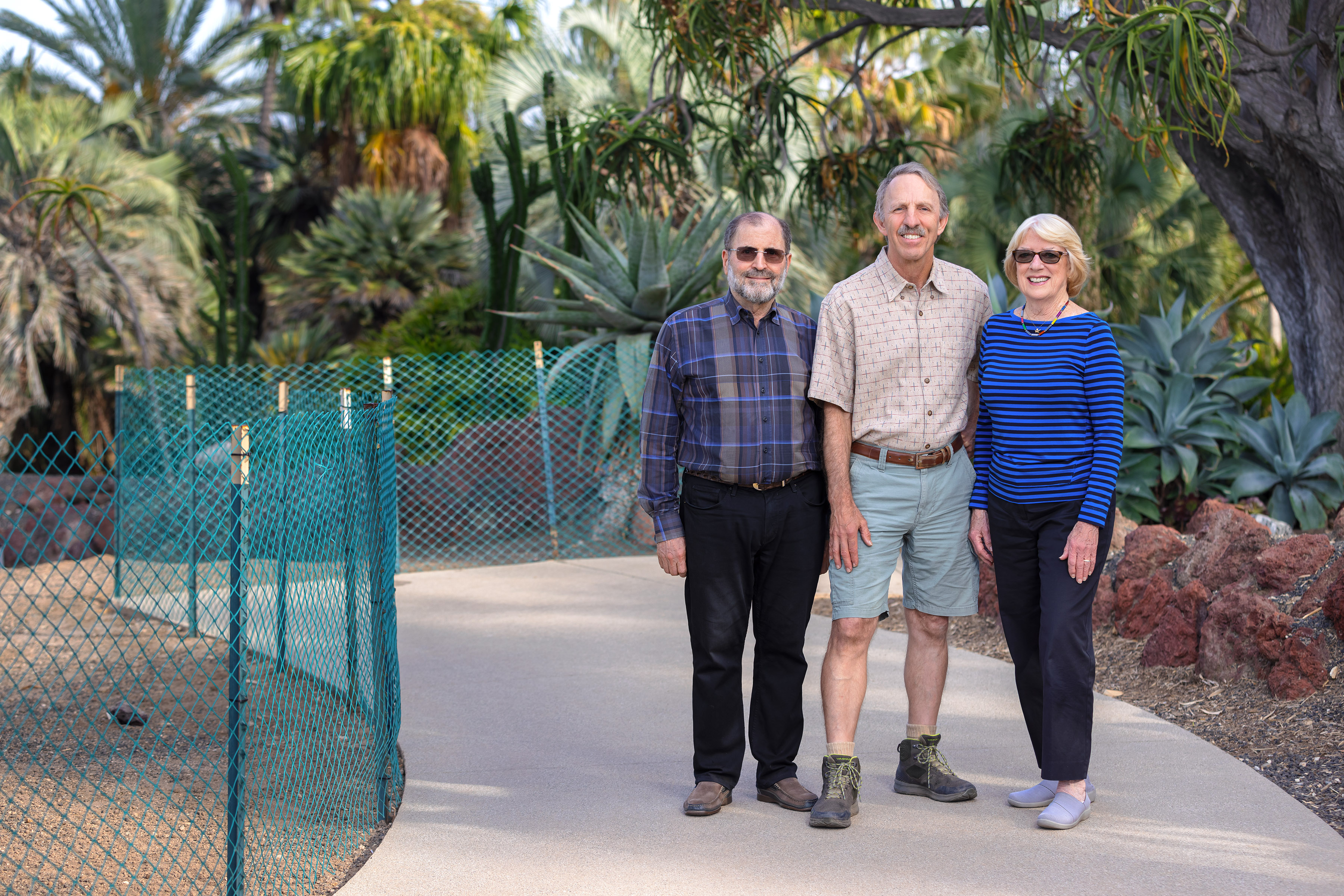 Three people stand at the entrance to the Desert Garden.