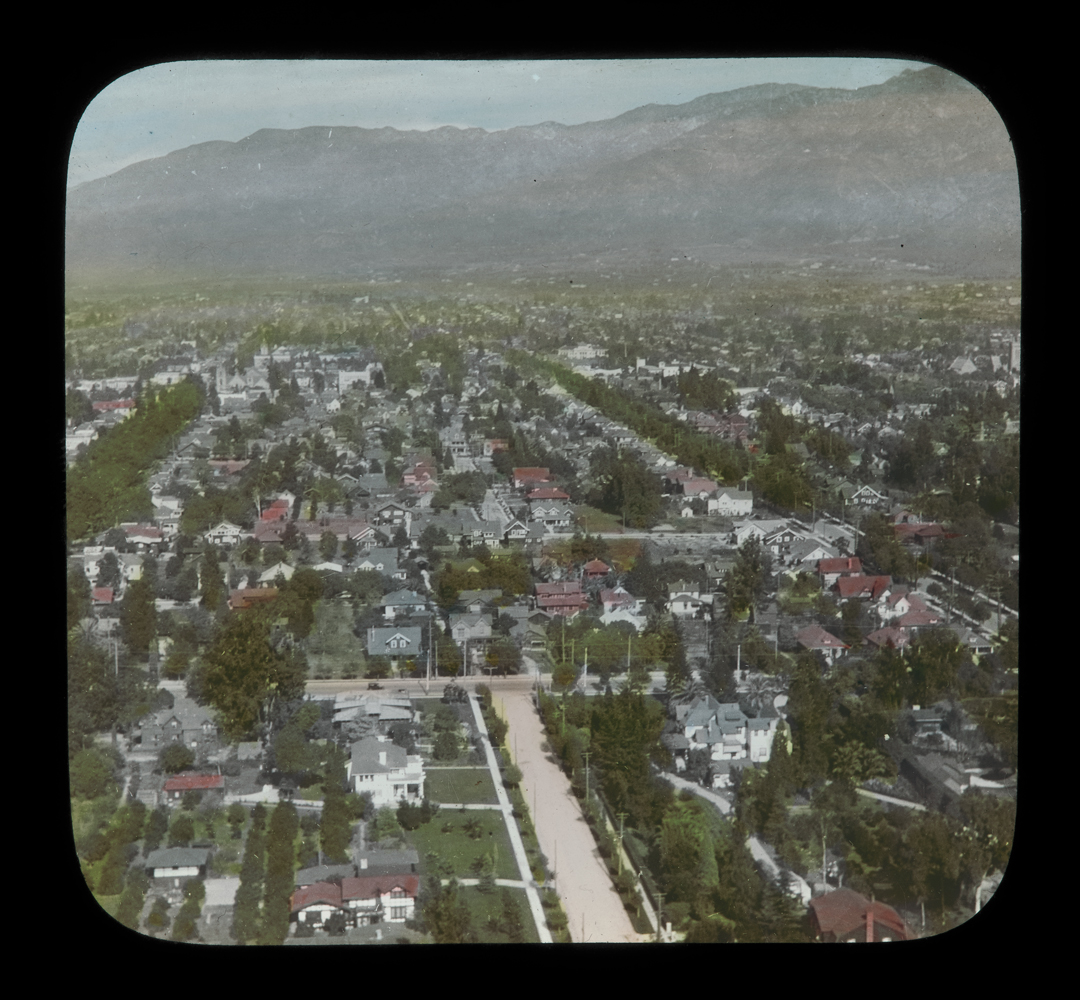 An aerial view of a city with mountains in the distance.