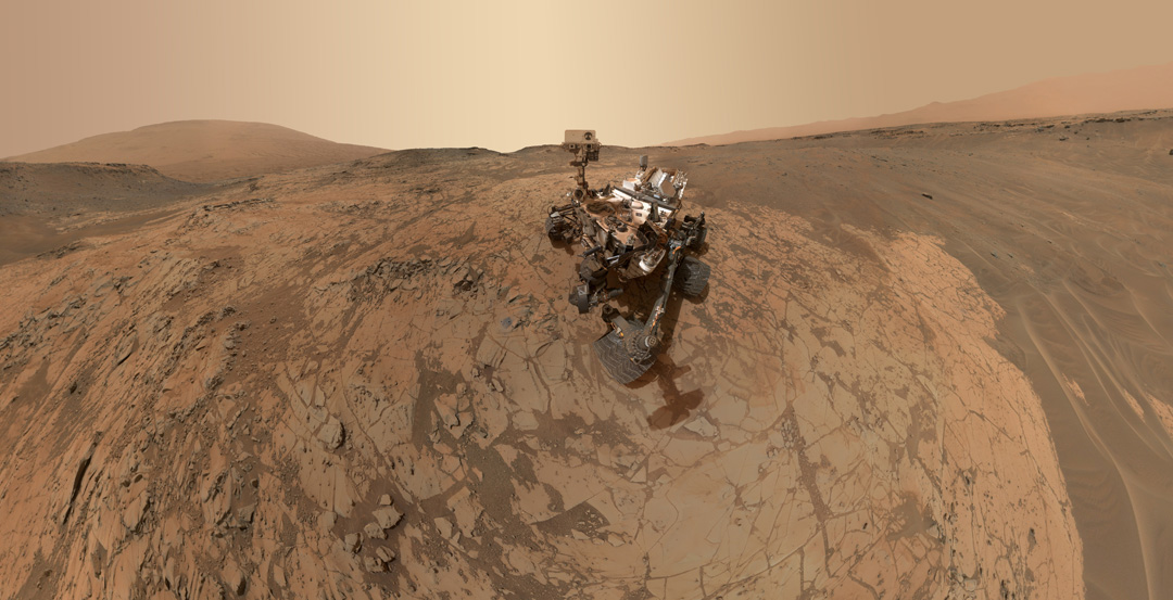 A robotic vehicle on the dry landscape of Mars.