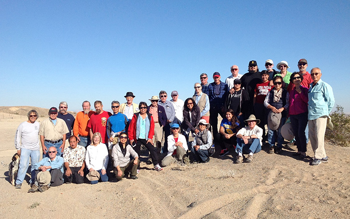 A group of people in a sandy landscape.