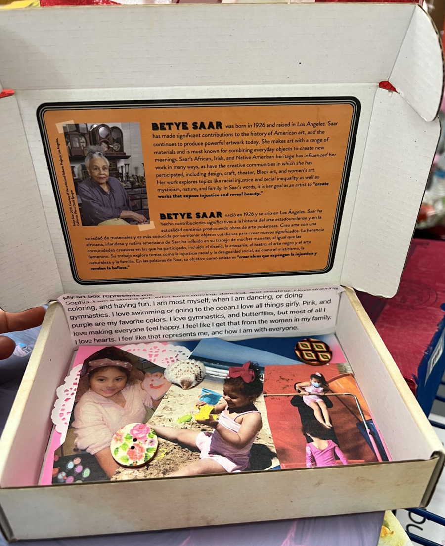 A box filled with photos of a child, various found objects, and a typed statement.