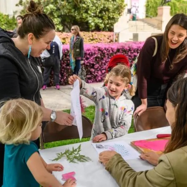 kids and parents at outdoor learning table