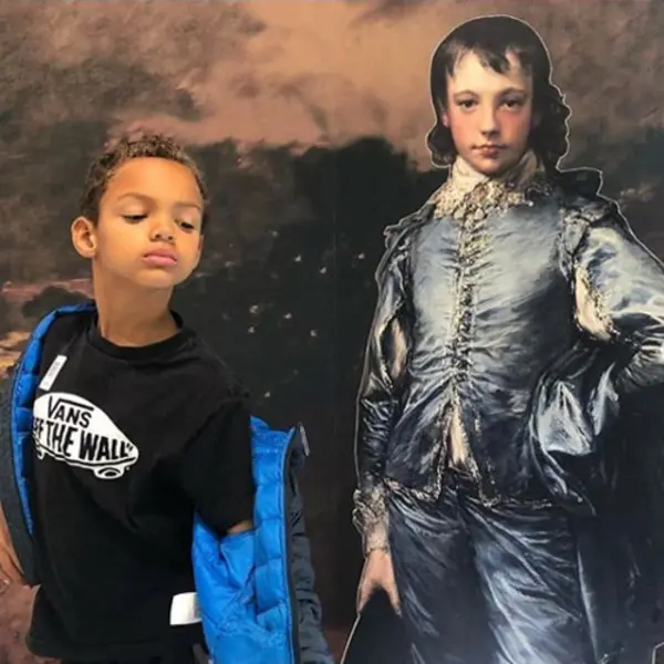 young boy taking a selfie with Blue Boy cutout