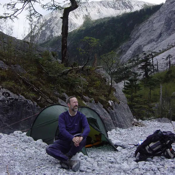 Stephen Blackmore by tent in the mountains