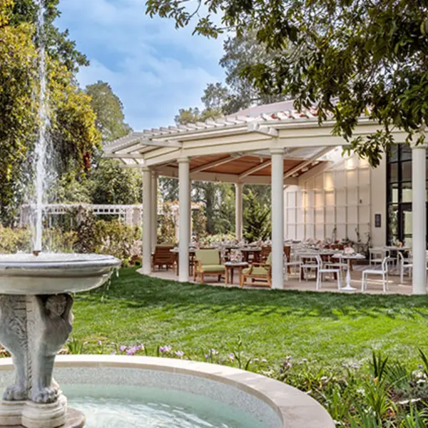 A 17th century fountain reveals a covered patio in the background.