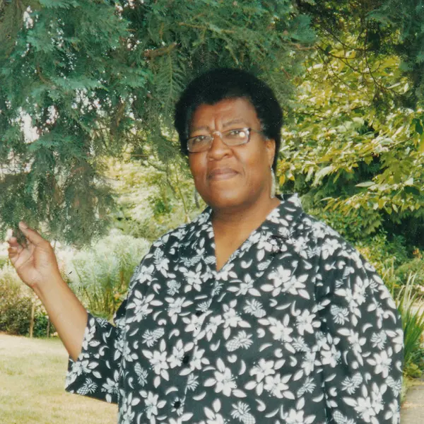 Octavia E. Butler standing by a tree.