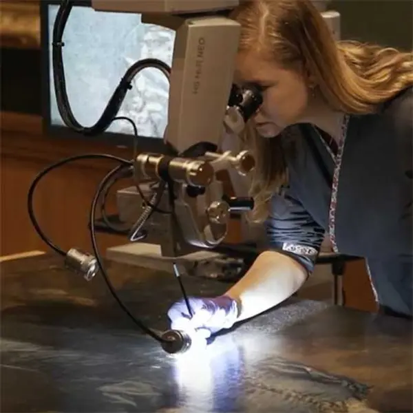 Conservator working on restoring Blue Boy