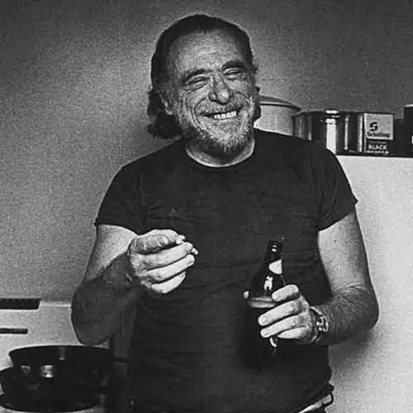 Charles Bukowski holding a cigarette and a beer