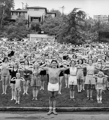 old b/w photo of adults and kids in workout clothes