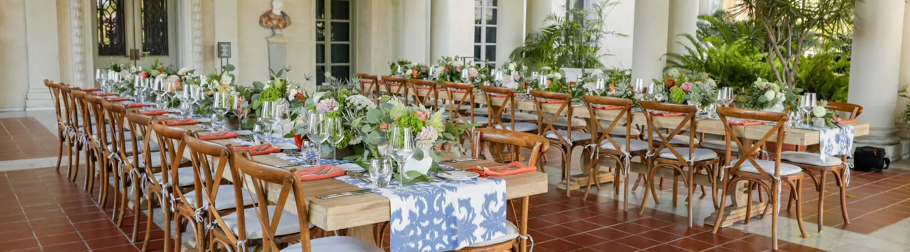 Two rows of wooden tables set up for a spring event.