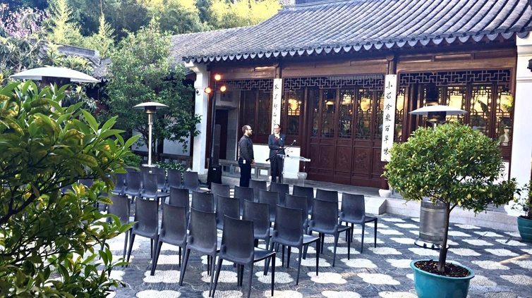 Rows of black chairs sit ready for a presentation.