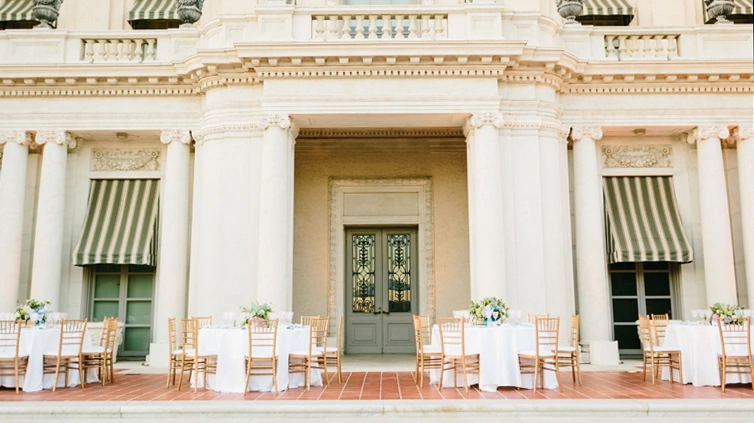 Round event tables set in front of the HUG's back door.