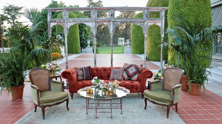 Burnt red-colored couch and mint green chairs.