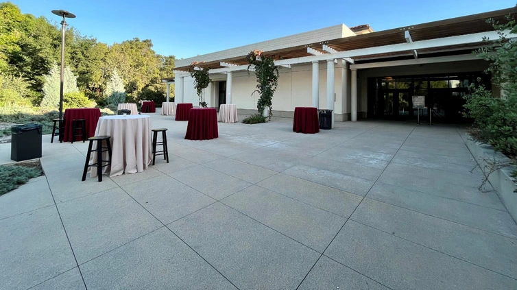 Wide view of an outdoor terrace with high tables.	