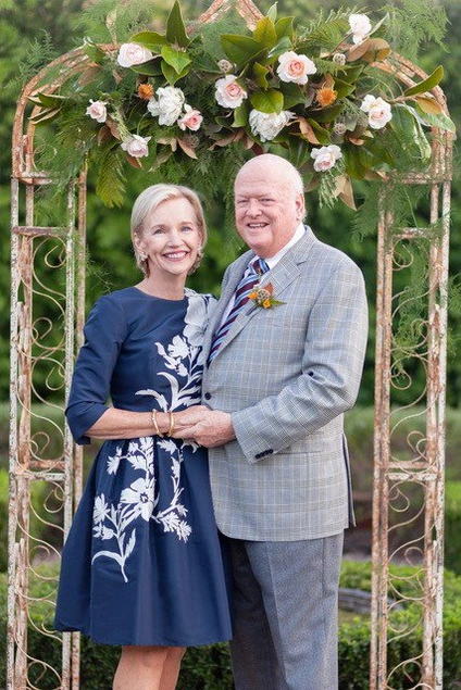 couple under a rose pergola