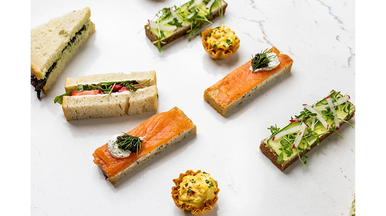 A selection of small finger foods are laid out on a table.