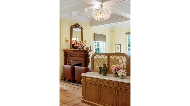 Interior view of a tea room with refined decor, eggshell walls, and seating in front of a fireplace.