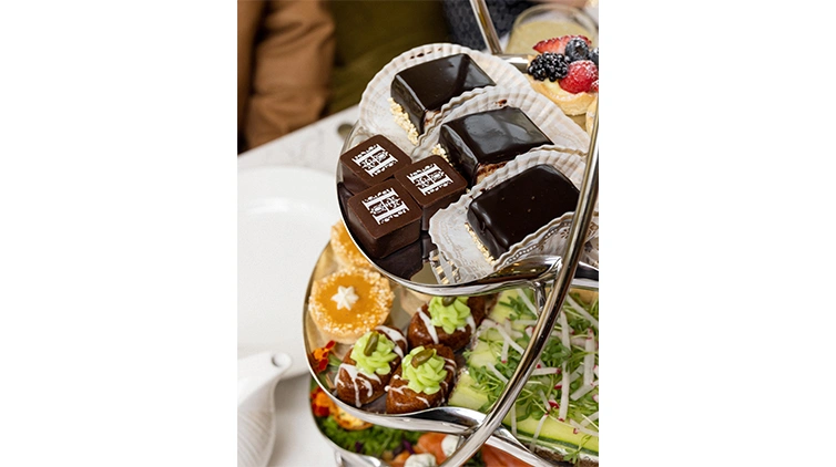 Close-up of a multi-tiered stand with petite desserts finger foods.