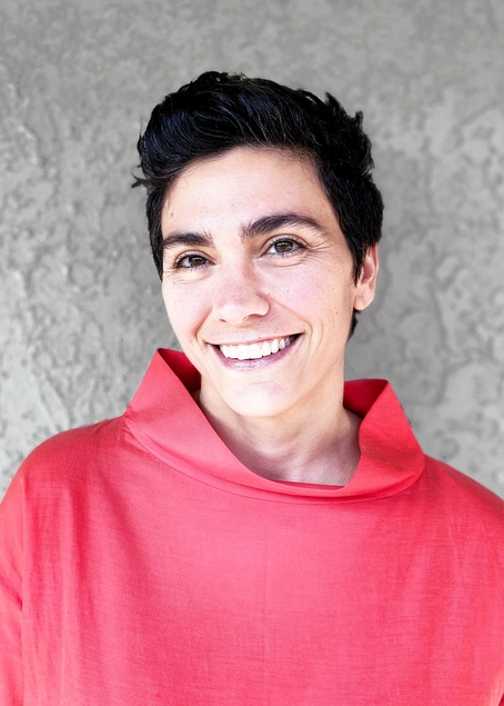 A photograph of a person in a red shirt.