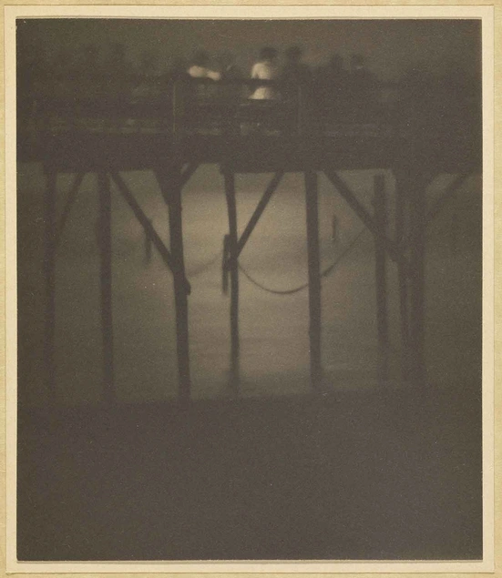 Karl F. Struss, Crowded Pier by Moonlight, Arverne, Long Island, New York, 1910–1912, sepia toned platinum print, 4 1/4 × 3 5/8 in. The J. Paul Getty Museum, Los Angeles. © 1983 Amon Carter Museum of Art, Fort Worth, Texas.