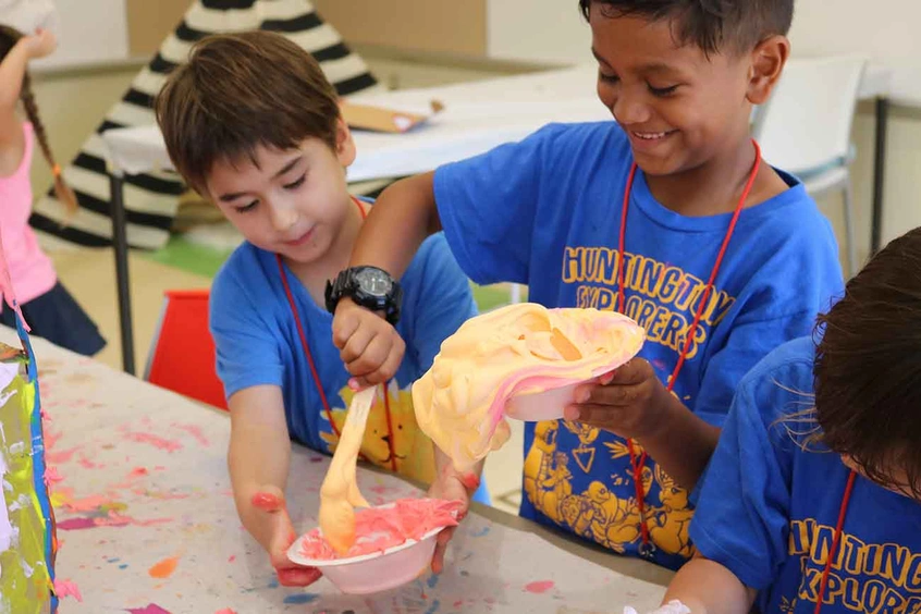 Campers pouring paint into bowl