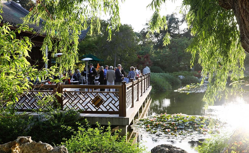 guests on deck of Chinese Garden overlooking lake