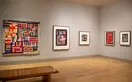 Bendolph’s President quilt hangs on gallery wall next to prints of other quilts.