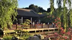 An setting sun shines golden light on a deck filled with people.