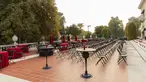 Rows of chairs plus deep red tablecloth-covered tables.