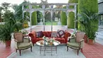 Burnt red-colored couch and mint green chairs.