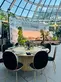 Round event table setup under glass dome.