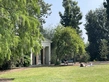 Visitors relax in front of a stone structure in the Australian Garden.