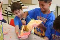 Campers pouring paint into bowl