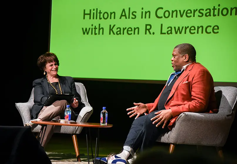 Two people in conversation on a stage.