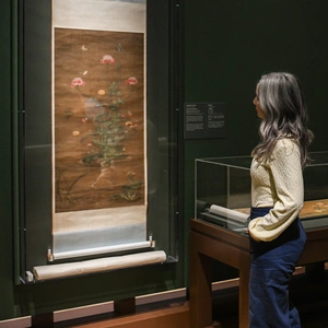 A person looks at a traditional Chinese scroll painting.