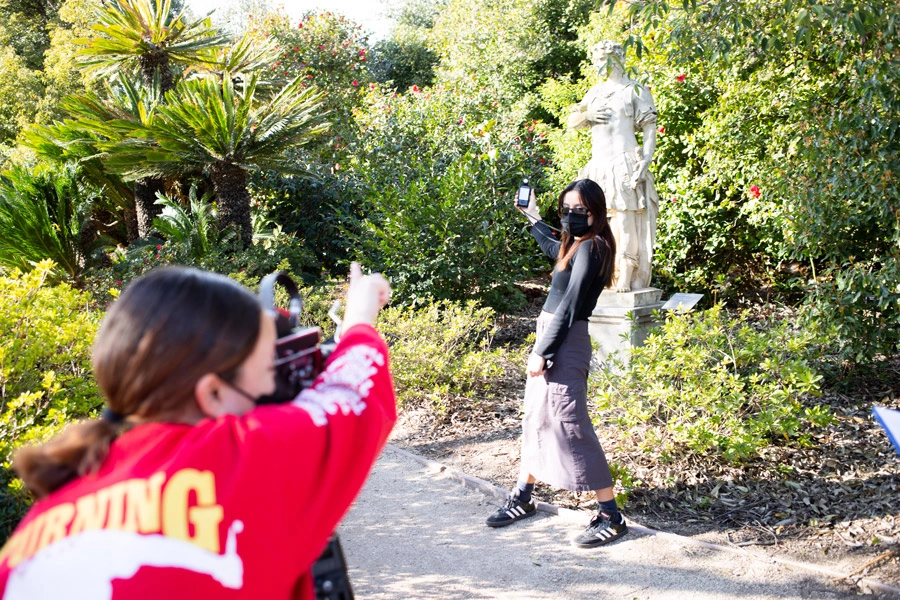 Xochilt Garcia and Ixchel Cruz film in one of The Huntington’s gardens.