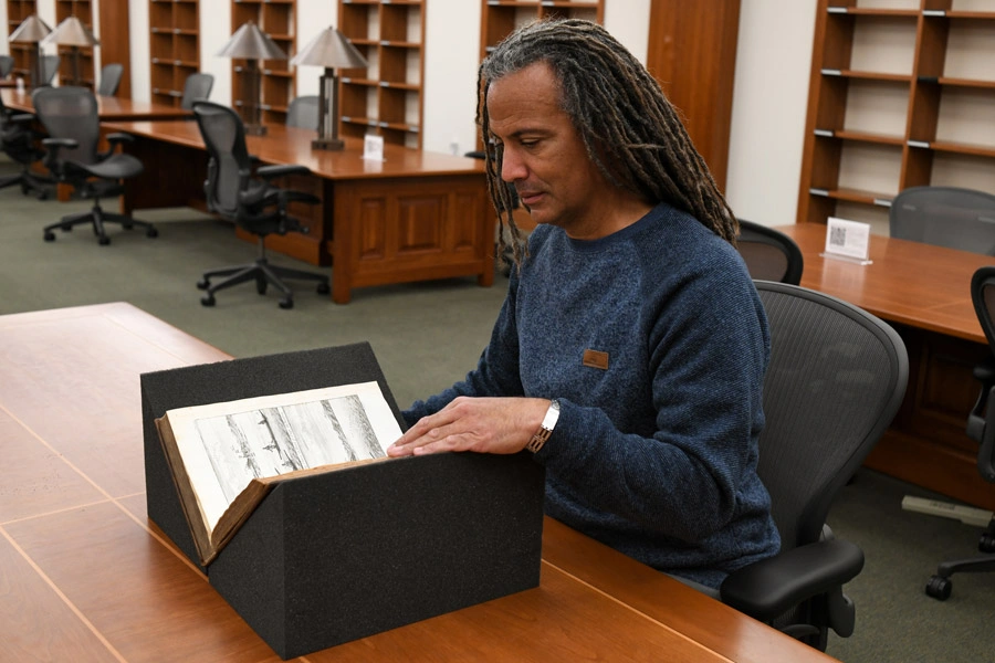 Kevin Dawson looking at a book.