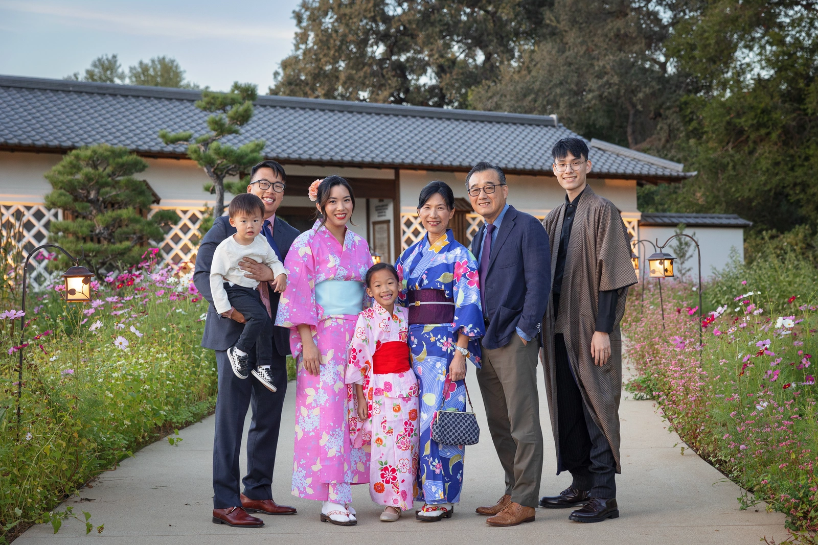 A group of people pose for the camera in front of a building.