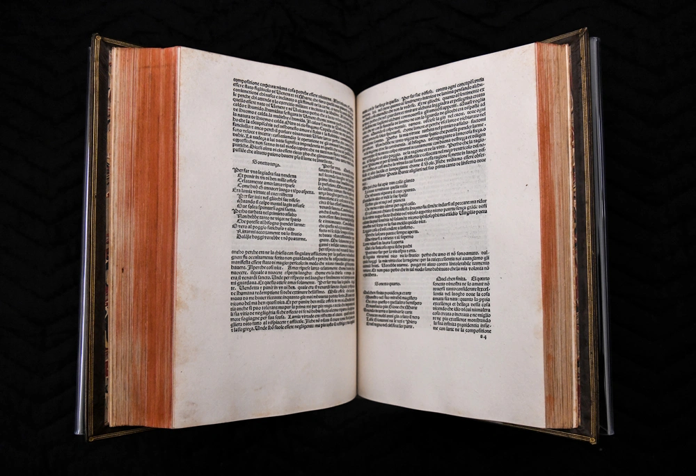 Pages of an opened book with ornate text.