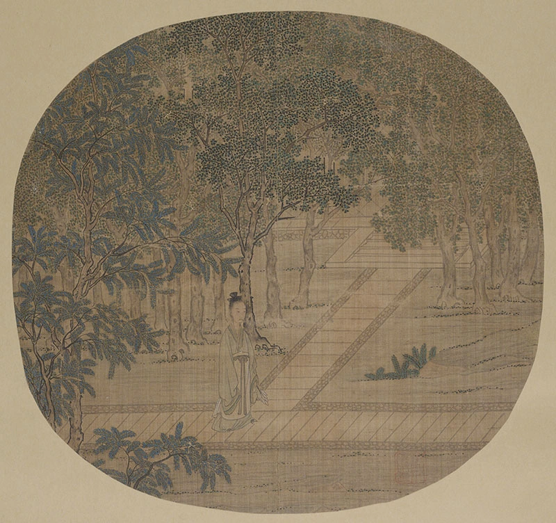 Round fan spread flat with drawing of a tree revealing walkways.