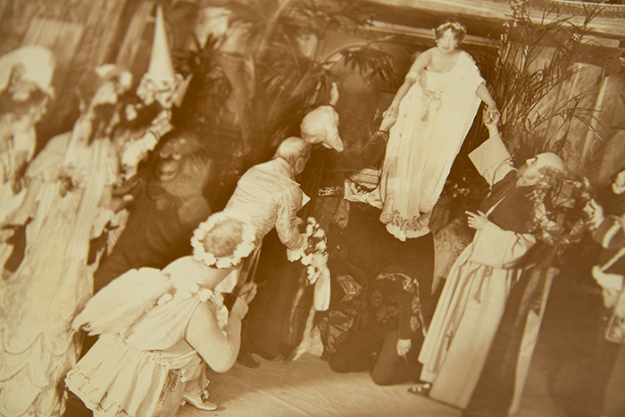 Actress Olga Nethersole (1867–1951), playing the role of Sappho, descends from a pedestal on which she has been posing as a statue, stepping down on a ‘staircase’ formed by the backs of men. Detail of Olga Nethersole and cast in the Clyde Fitch production of “Sapho,” Act I, 1900. J. Byron, photographer. L.E. Behymer Collection. The Huntington Library, Art Collections, and Botanical Gardens.