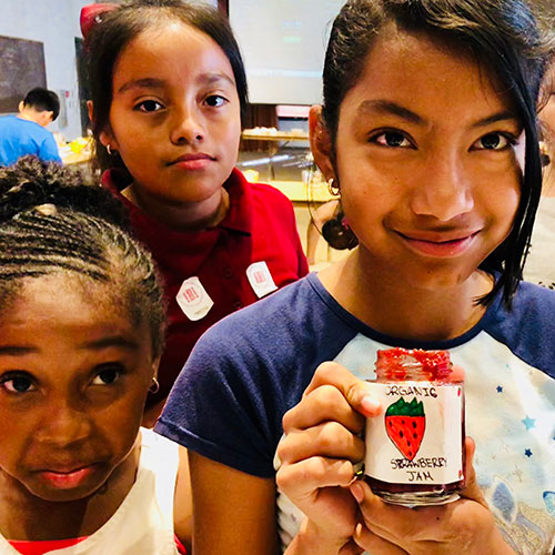 A Place Called Home participants holding jam jars